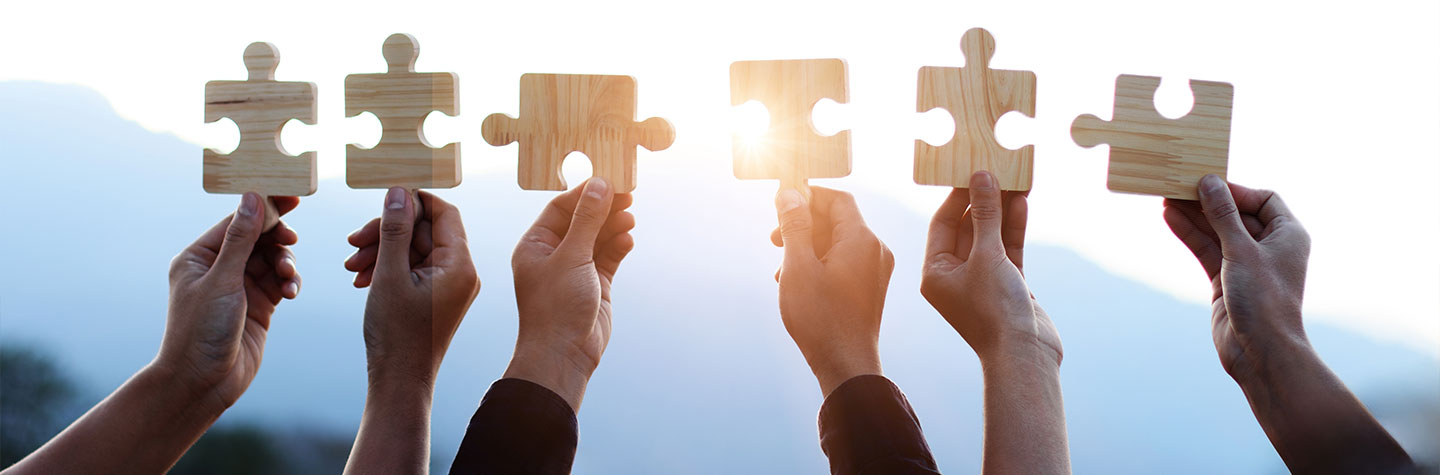 hands holding large puzzle pieces