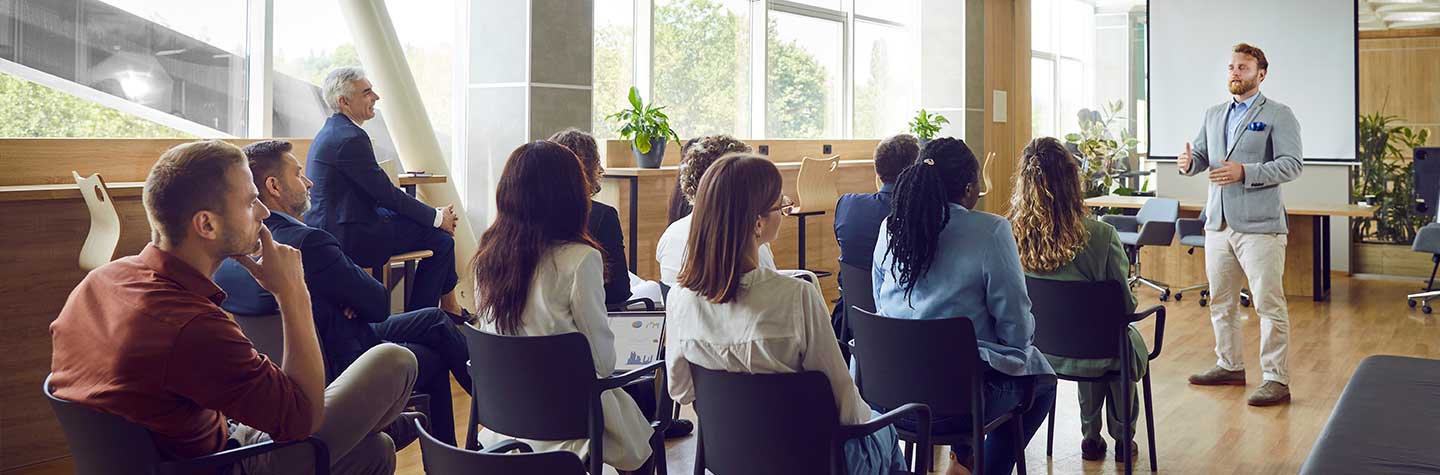 conference training with speaker presenting to group
